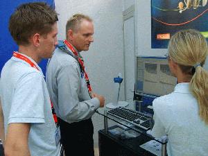 Andreas Bergner  (to the left) and Wanja Stenberg (to the right) get a product demo by Claus Petersen from GN ReSound